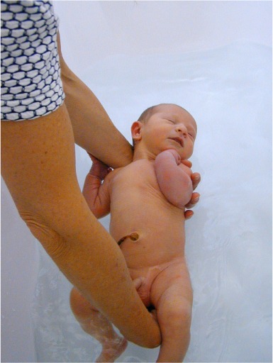 Baby gets a warm water cleaning